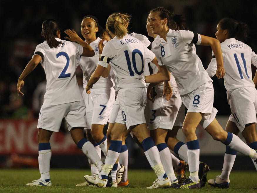 Jess Clarke (second from left) is congratulated by team-mates after opening the scoring against USA.